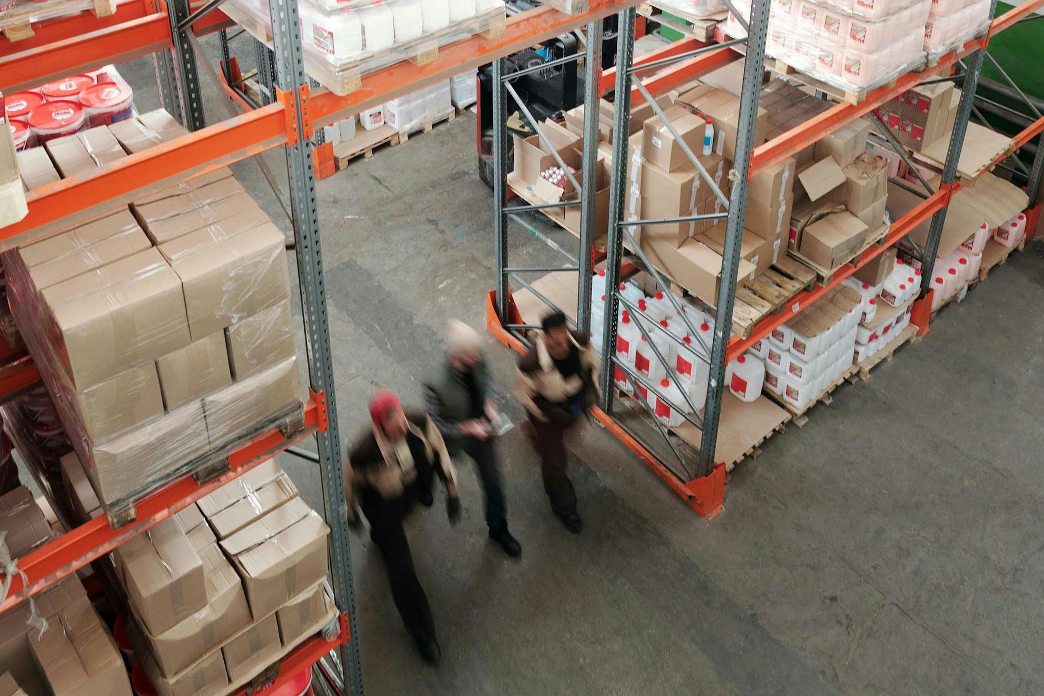 Warehouse with many cardboard boxes and shelves.