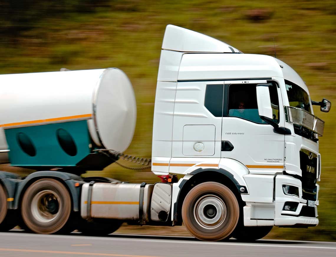 valkoinen rekka ajaa lujaa maantiellä